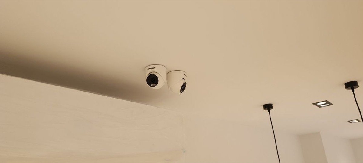 Two CCTV dome cameras mounted together on the ceiling
