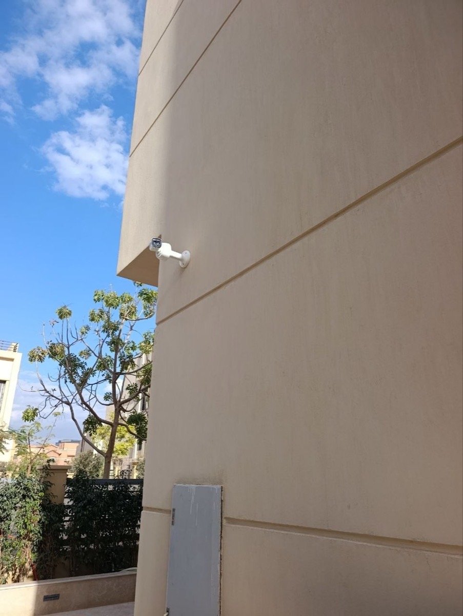 CCTV camera mounted at a corner of the villa, overlooking the garden
