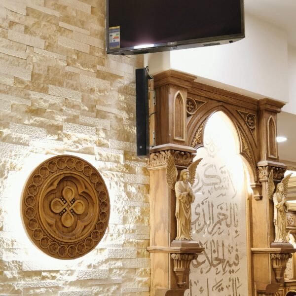 Mounted display and speaker integrated into a carved wooden archway