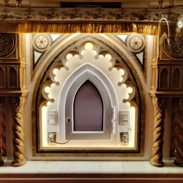 Lighting and switches integrated into an ornate architectural niche