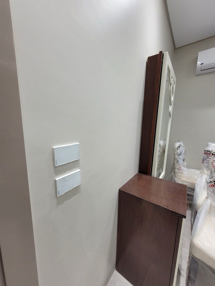 Smart touch switch beside a wall-mounted air conditioning unit