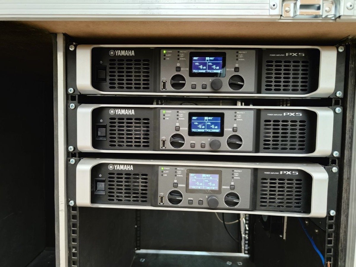 Rack-mounted Yamaha power amplifiers driving the event's sound system